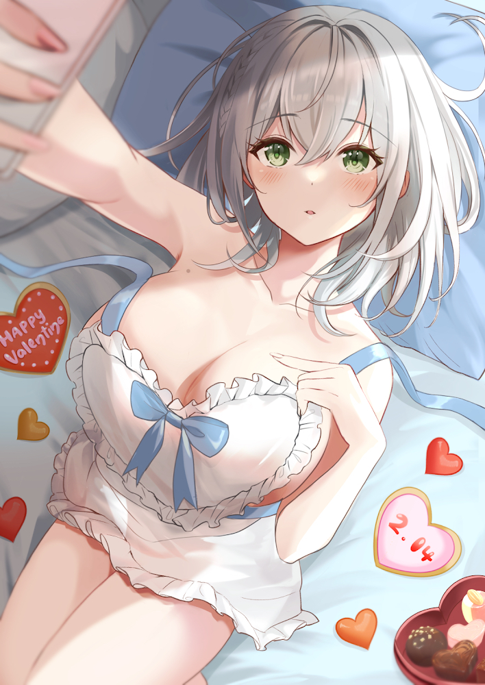 1girls 2022 alternate_costume apron bangs blurry blurry_foreground blush braid breasts chocolate cleavage collarbone cowboy_shot eyebrows_visible_through_hair female female_focus female_only frilled_apron frills green_eyes grey_hair hair_between_eyes hand_on_own_chest happy_valentine head_tilt heart highres holding holding_phone hololive hololive_fantasy hololive_japan indoors konasu_(sndk1480) large_breasts light-skinned_female light_skin looking_at_viewer lying medium_hair messy_hair mole mole_on_breast naked_apron on_back on_bed open_mouth parted_lips phone pillow selfie shirogane_noel short_hair silver_hair solo strap_slip valentine virtual_youtuber