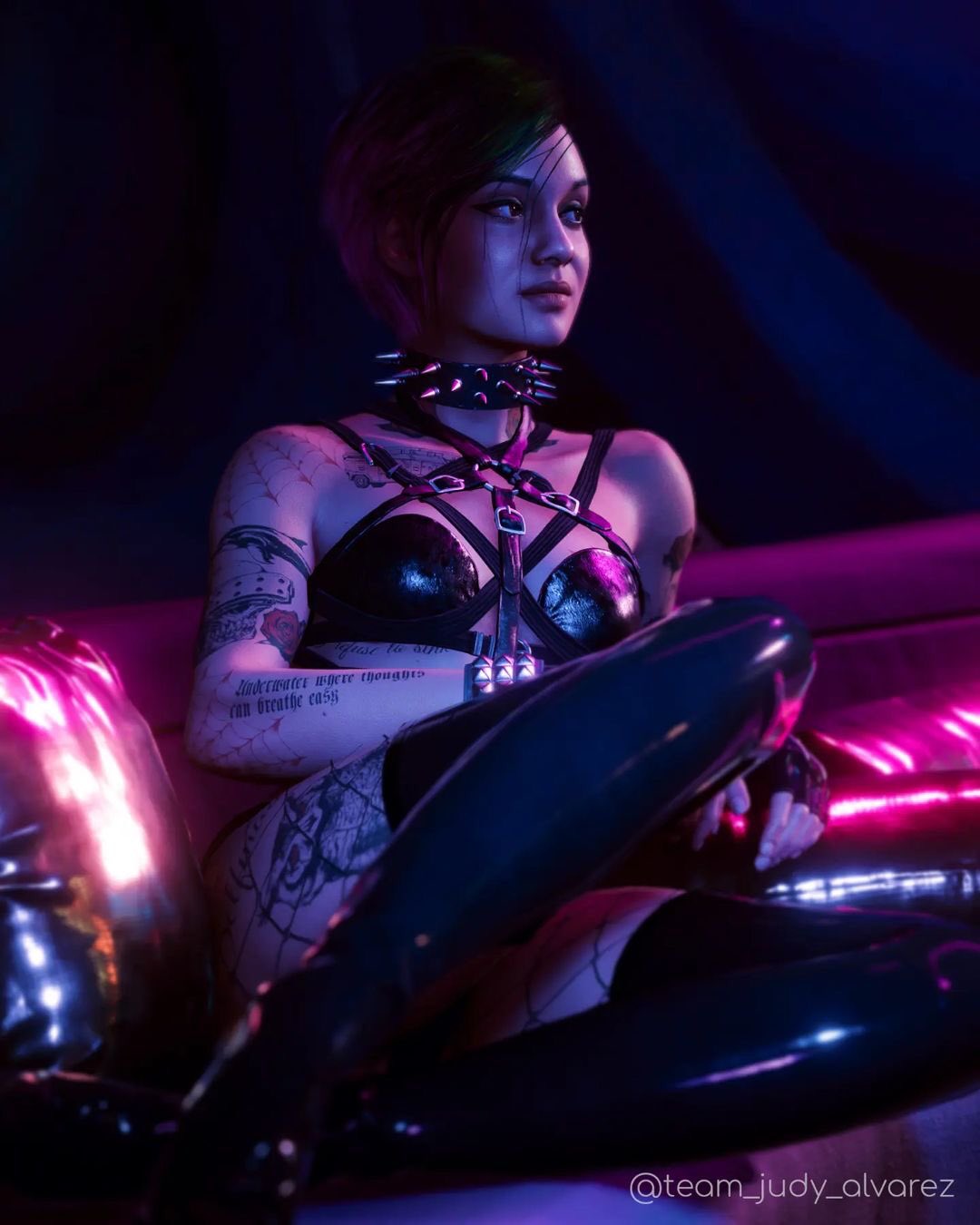 1girls, 3d, 3d (artwork), arm tattoo, boots, bra, cd projekt red, collar, couch, cyberpunk 2077, female, female only, fishnet legwear, fishnet pantyhose, fishnets, front view, green hair, harness, hi res, highres, judy alvarez, leather boots, looking away, multicolored hair, pink hair, short hair, solo, spiked bracelet, spiked collar, tattoo, tattoo on arm, tattoo on chest, tattoo on legs, tattooed arm, tattoos, team judy alvarez, the grindera, thigh boots, thighhighs, two-tone hair