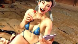 2girls bikini busty chun-li cleavage closed_eyes dark_hair ggroler holding_lollipop holding_object holding_phone laughing lipstick lollipop midriff multiple_girls open_mouth phone sitting_on_person street_fighter street_fighter_6