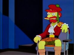 1boy balls circumcised double_dicks_(artist) edit exposed_penis facial_hair flaccid foreskin groundskeeper_willie human kilt male male_only penis penis_under_skirt red_hair screenshot screenshot_edit sitting solo the_simpsons unibrow yellow_skin