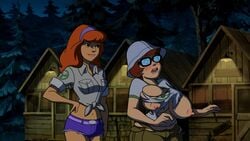 2girls accurate_art_style alternate_breast_size belt black-framed_eyewear black-framed_glasses blush breast_expansion brown_hair bursting_breasts cabin camp_scare cargo_pants cargo_shorts chubby cleavage daphne_blake denim_shorts edit embarrassed erect_nipples female_only forest freckles glasses hand_on_hip hanna-barbera huge_breasts jean_shorts long_hair medium_hair midriff navel nerd nipples orange_hair outdoors scooby-doo scooby-doo!_camp_scare screenshot screenshot_edit shirt short_shorts short_sleeves shorts tearing_clothes tied_shirt tight_clothing trees velma_dinkley white_shirt yetig