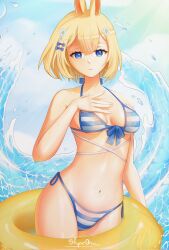 animal_ears artist_name bangs bikini blonde_hair blue_bikini blue_eyes breasts bunny_ears closed_mouth collarbone cowboy_shot day eyebrows_visible_through_hair female flower hair_between_eyes hair_flower hair_ornament halterneck innertube looking_at_viewer medium_breasts navel short_hair side-tie_bikini skyezartz solo standing stomach striped striped_bikini swimsuit vyugen water white_flower yenko