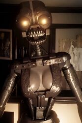 ai_generated animatronic breasts endoskeleton five_nights_at_freddy's five_nights_at_freddy's:_security_breach glowing_eyes looking_at_viewer metal_skin orange_eyes pixai pre_sex robot robot_girl the_mimic_(fnaf) upper_body